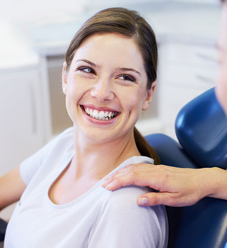 smiling young woman in a dental chair