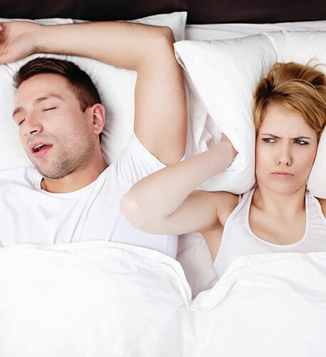 a woman having trouble sleeping because of her husbands sleep apnea